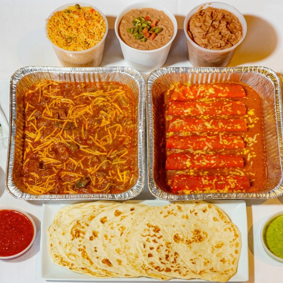 Mexican feast with enchiladas, saucy shredded meat, rice, beans, tortillas, crema, pico de gallo, and red and green salsas.